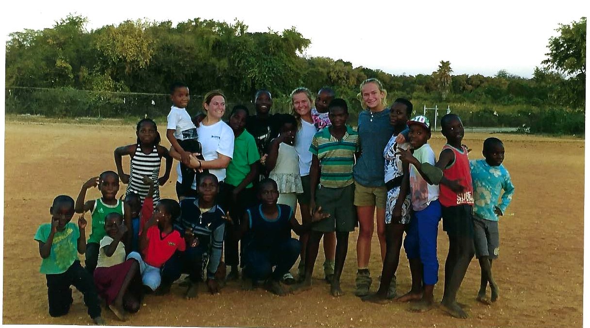 Diane and companions with children during a visit in Africa